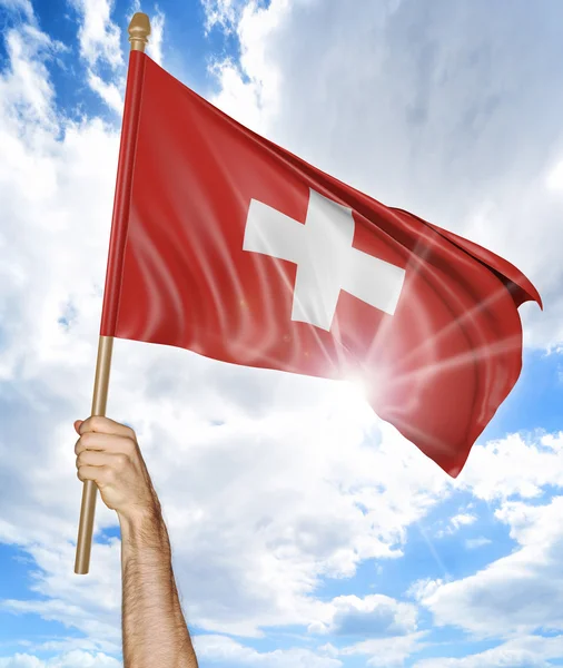 Person's hand holding the Swiss national flag and waving it in the sky, 3D rendering — Stock Photo, Image