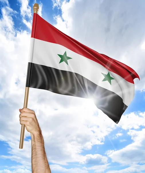 シリアの国旗を押し、空、3 d レンダリングでそれを振って、人の手 — ストック写真