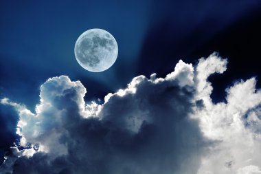 Ay ışığında parlayan güzel beyaz bulutlar ile gece gökyüzünde büyük dolunay