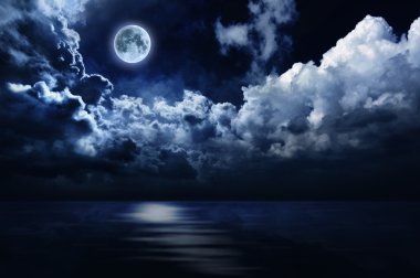 Full moon in night sky over water clipart