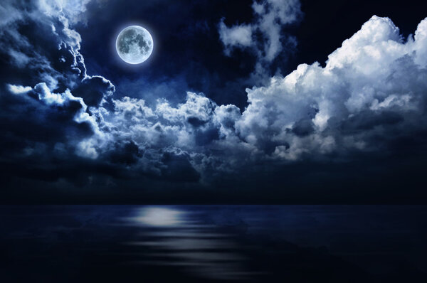 Full moon in night sky over water