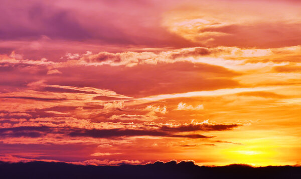 Dusk sky set colorfully ablaze by the setting sun.