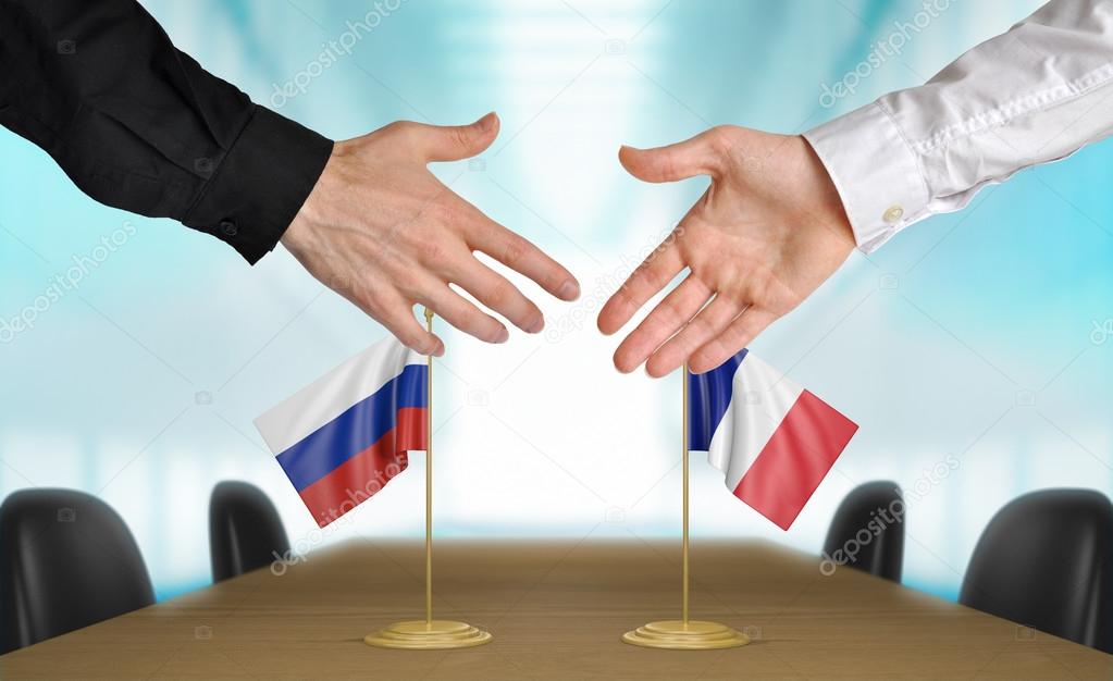 Russia and France diplomats agreeing on a deal