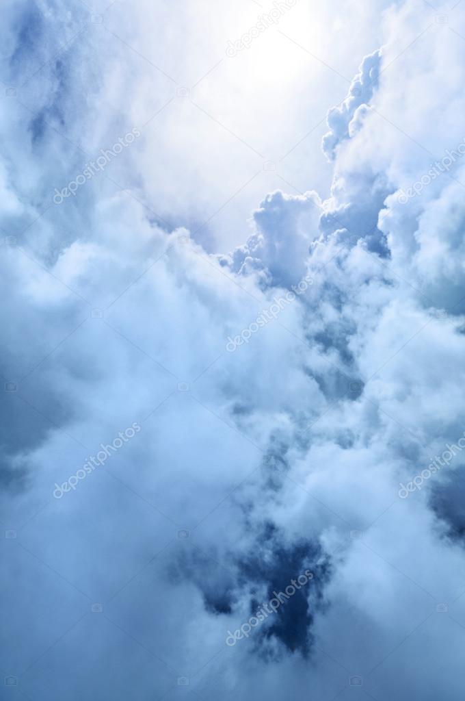 Heavenly blue and white clouds softly backlit by light