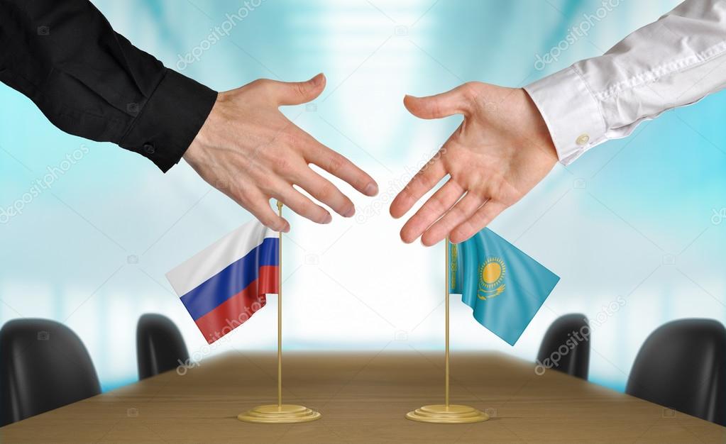 Russia and Kazakhstan diplomats agreeing on a deal