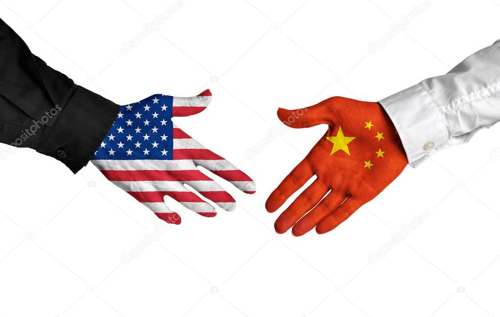 American and Chinese leaders shaking hands on a deal agreement