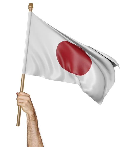 Mano orgullosamente ondeando la bandera nacional de Japón — Foto de Stock