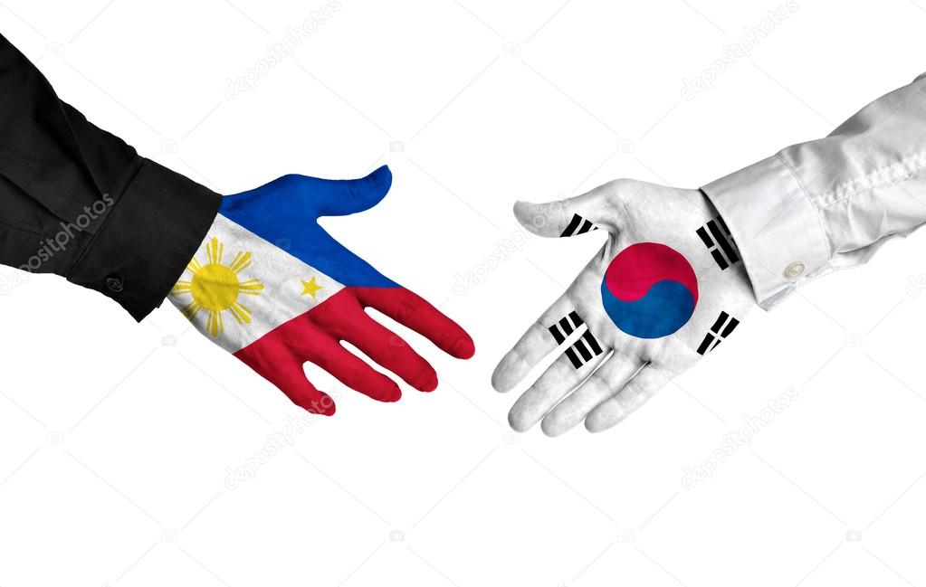 Philippines and South Korea leaders shaking hands on a deal agreement