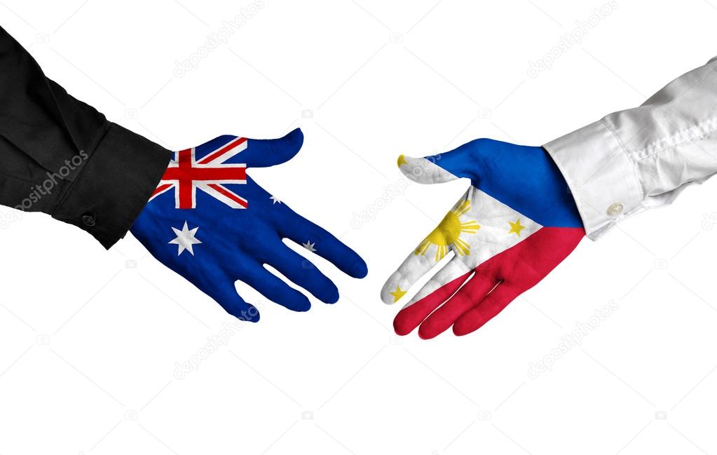 Australia and Philippines leaders shaking hands on a deal agreement