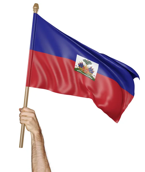 Mão orgulhosamente acenando a bandeira nacional do Haiti — Fotografia de Stock