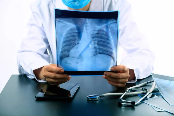 Woman Doctor Looking at X-Ray Radiography in patient's Room, doctor radiology looking x-ray film of patient at hospital.