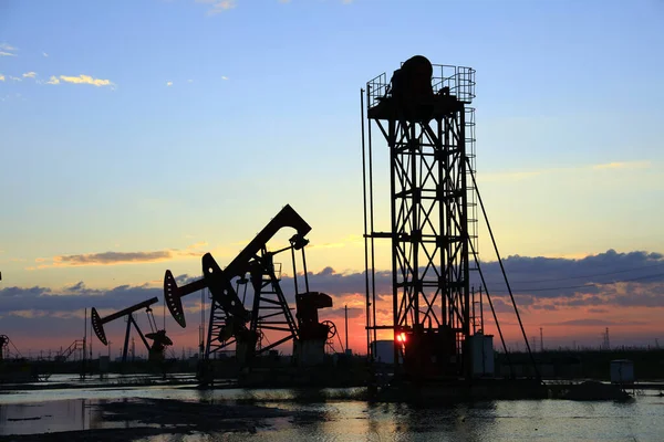 Oil fields in the evening, oil field derrick in the evening