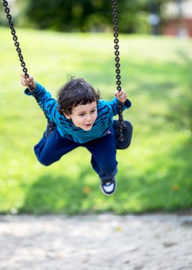 Little child on swing, smiling