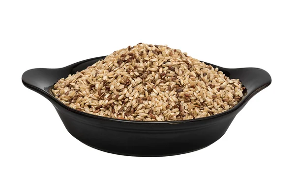 Raw brown rice in deep porcelain plate — Stock Photo, Image