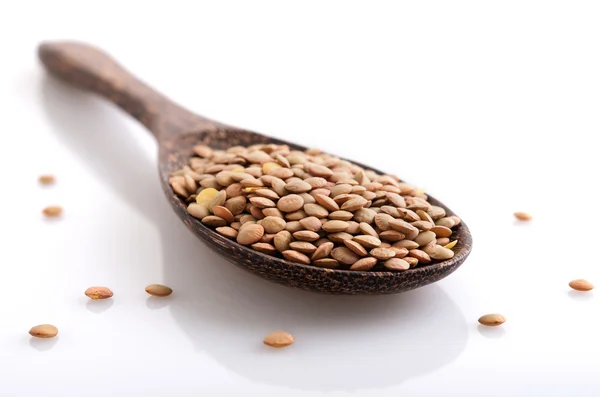 Lentil on wooden spoon — Stock Photo, Image