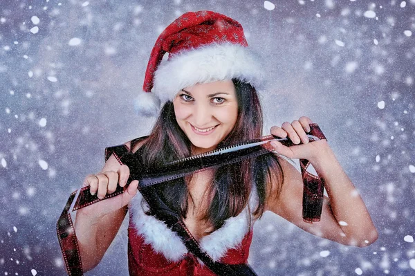 Chica ayudante de Santa con película fotográfica en las manos —  Fotos de Stock