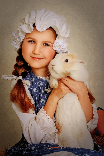 Girl playing with Easter bunny. — Stock Photo, Image