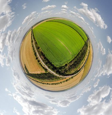 Small planet with a view of a bridge, wheat and corn fields under the blue sky in Moldova, spherical panorama on DJi Mavic Mini 2