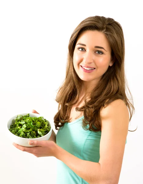 Smiling woman holding a bowl of Kale — Stock Photo, Image