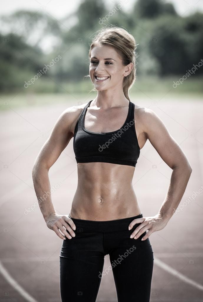 Happy young woman with slim and toned body Stock Photo by