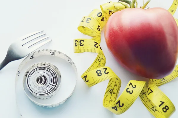 Vegetables and fruits for weight loss, a measuring tape, diet, weight loss — Stock Photo, Image