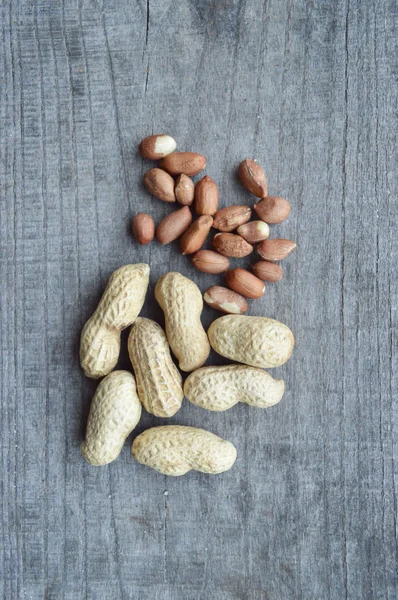 Walnuts,almonds,hazelnuts closeup on wooden background,many varieties of nuts — Stock Photo, Image