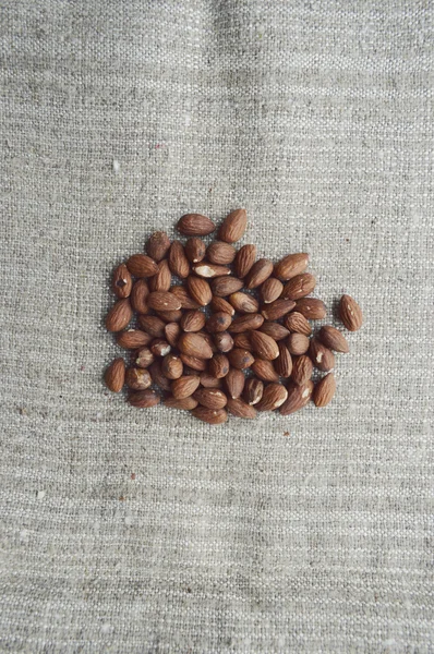 Almonds closeup on wooden background.Walnuts,almonds,hazelnuts closeup on wooden background,many varieties of nuts — Stock Photo, Image