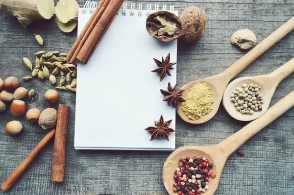 Seasonings,spices,recipe book,Notepad,write,pepper, peas,red pepper,black pepper,cardamom,star anise,cinnamon,coriander,cinnamon sticks,cloves,star — Stock Photo, Image