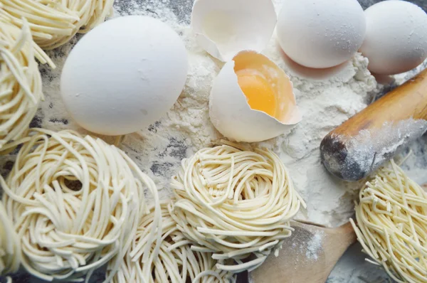 Stilleven met ruwe huisgemaakte pasta en ingrediënten voor pasta — Stockfoto