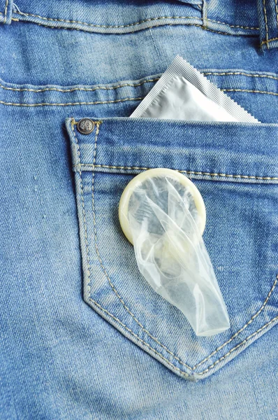 Condom in blue jeans pocket — Stock Photo, Image