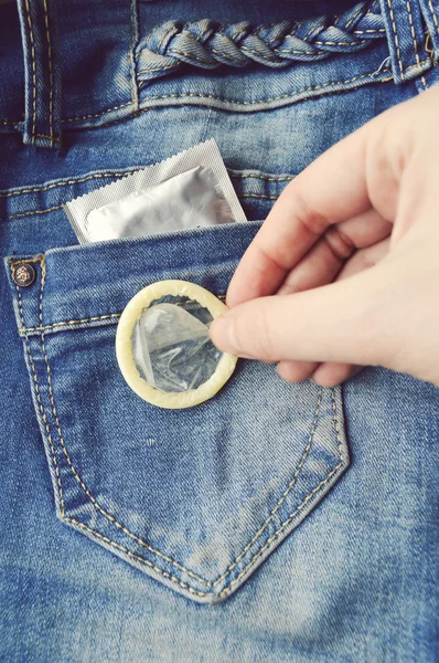 Condom in blue jeans pocket — Stock Photo, Image