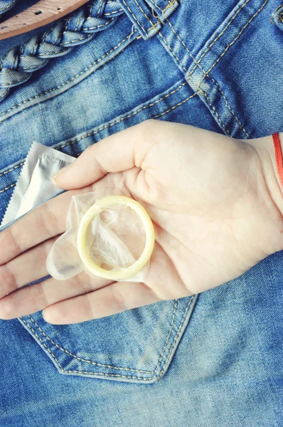 Condom in blue jeans pocket — Stock Photo, Image