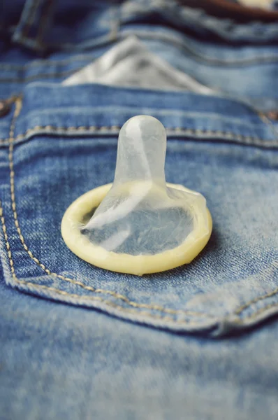 Condom in blue jeans pocket — Stock Photo, Image