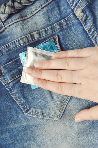 Condom in blue jeans pocket — Stock Photo, Image