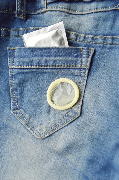 Condom in blue jeans pocket — Stock Photo, Image