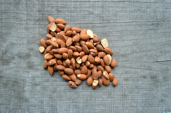 Almonds closeup on wooden background — Stock Photo, Image