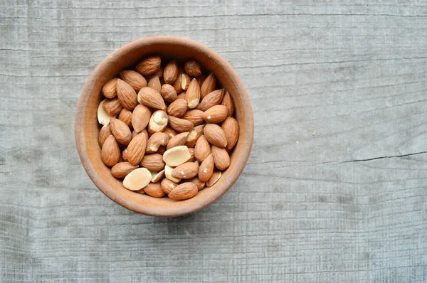 Almonds closeup on wooden background — Stock Photo, Image
