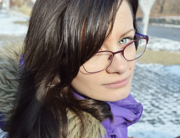 Beautiful girl in glasses with blue eyes close up .girl talking on the phone.girl makes selfi — стоковое фото