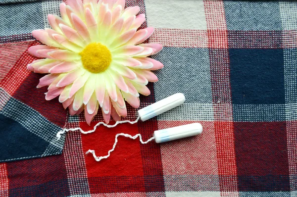 Kadın hijyen koruma, kırmızı bir arka plan üzerinde pamuk tampon, turuncu Gerber, sıhhi yastıkları ile yakın-up.menstruation takvimi — Stok fotoğraf