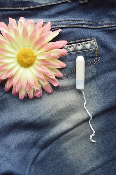 Woman hygiene protection, close-up.menstruation calendar with cotton tampons,orange Gerber,Sanitary pads on a red background — Stock Photo, Image