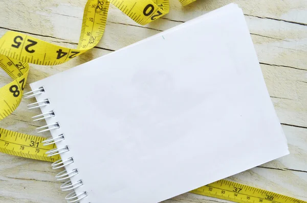 Notebook  and measuring tape — Stock Photo, Image