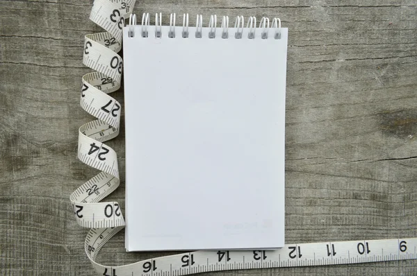 Empty notebook and measuring tape — Stock Photo, Image