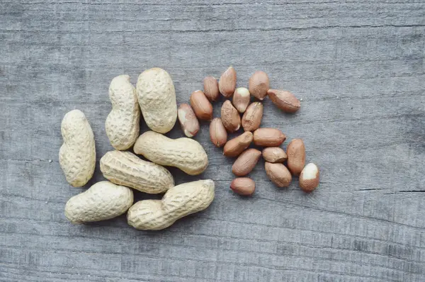 Nuts on rustic old wooden table — Stock Photo, Image