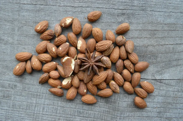 Nuts on rustic old wooden table — Stock Photo, Image