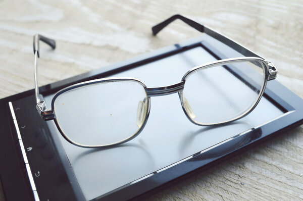 Black e-book and glasses