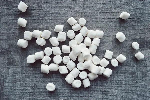 Marshmallows na dřevěný stůl — Stock fotografie