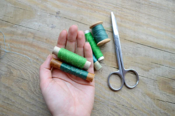 Hand holds the spool of thread — Stock Photo, Image