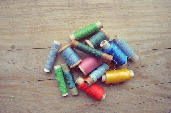 Spool of thread on wooden table — Stock Photo, Image