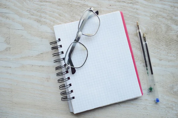 Notebooks with two pens and glasses — Stock Photo, Image