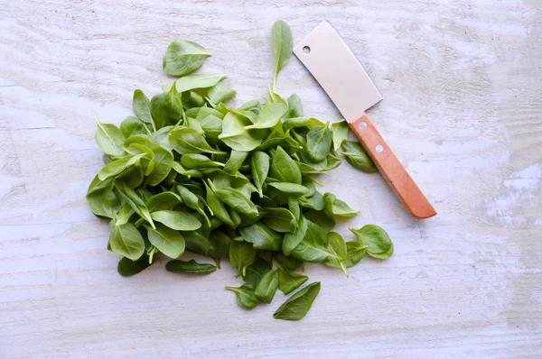 Spinach on wooden table — Stock Photo, Image